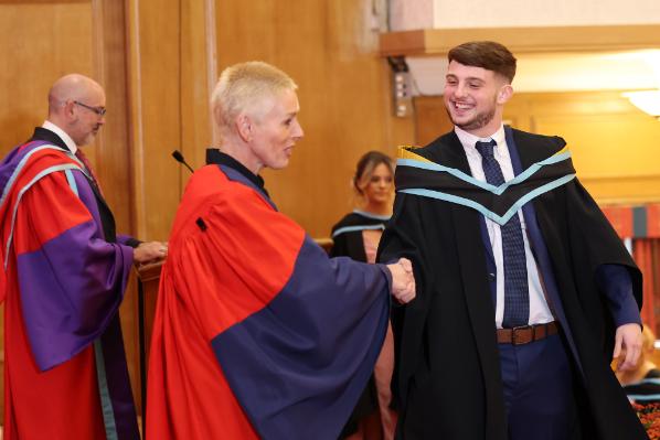 Graduates receiving their award